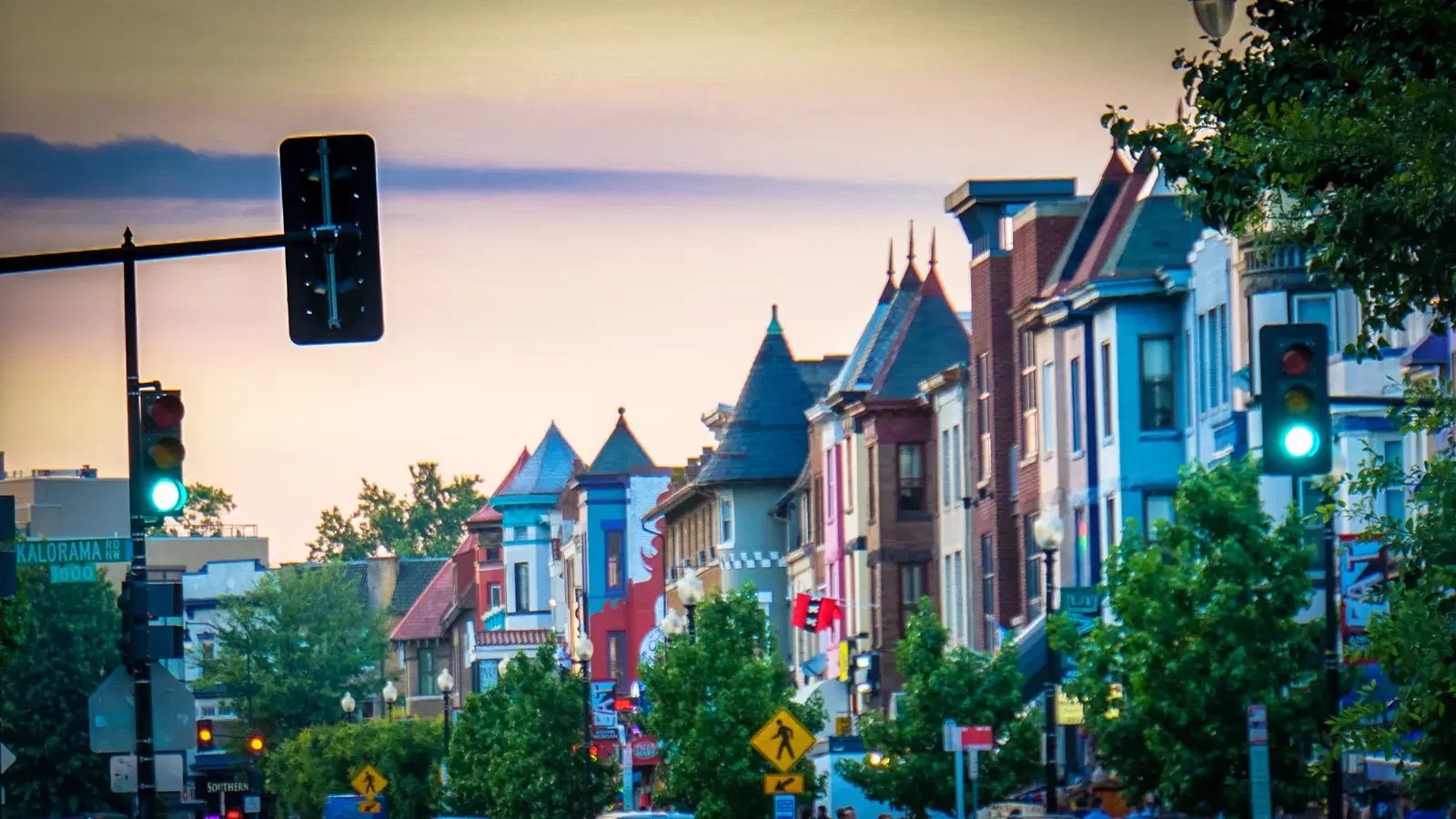 Turreted rowhouses along 18th Street NW at Kalorama Road in Adams Morgan at dusk, Washington, D.C.