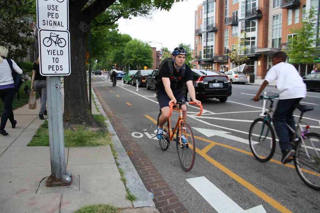 Two cyclists in the protected bike lane on 15th Street NW at P Street