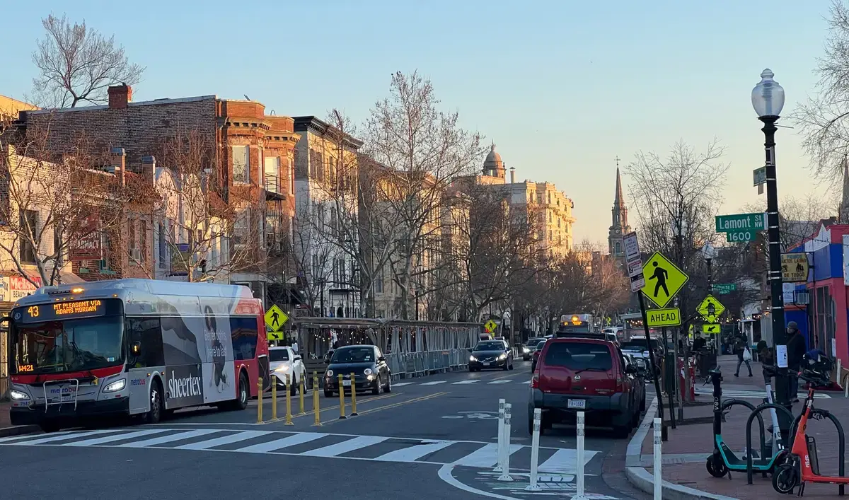 Golden-hour Mount Pleasant Street NW at Lamont St with the 43 Mt Pleasant via Adams Morgan Metrobus and streetcar-era commercial strip