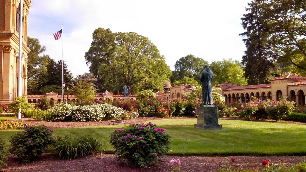 The rose garden, St. Francis statue, and Rosary Portico cloister at the Franciscan Monastery, Washington, D.C.