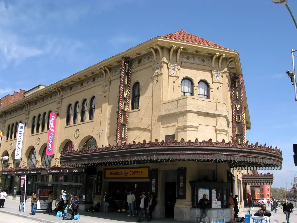 Corner view of the DC Tivoli Theatre (GALA Hispanic Theatre) at 14th & Park Rd, blue sky, twin TIVOLI blade signs and ornate marquee
