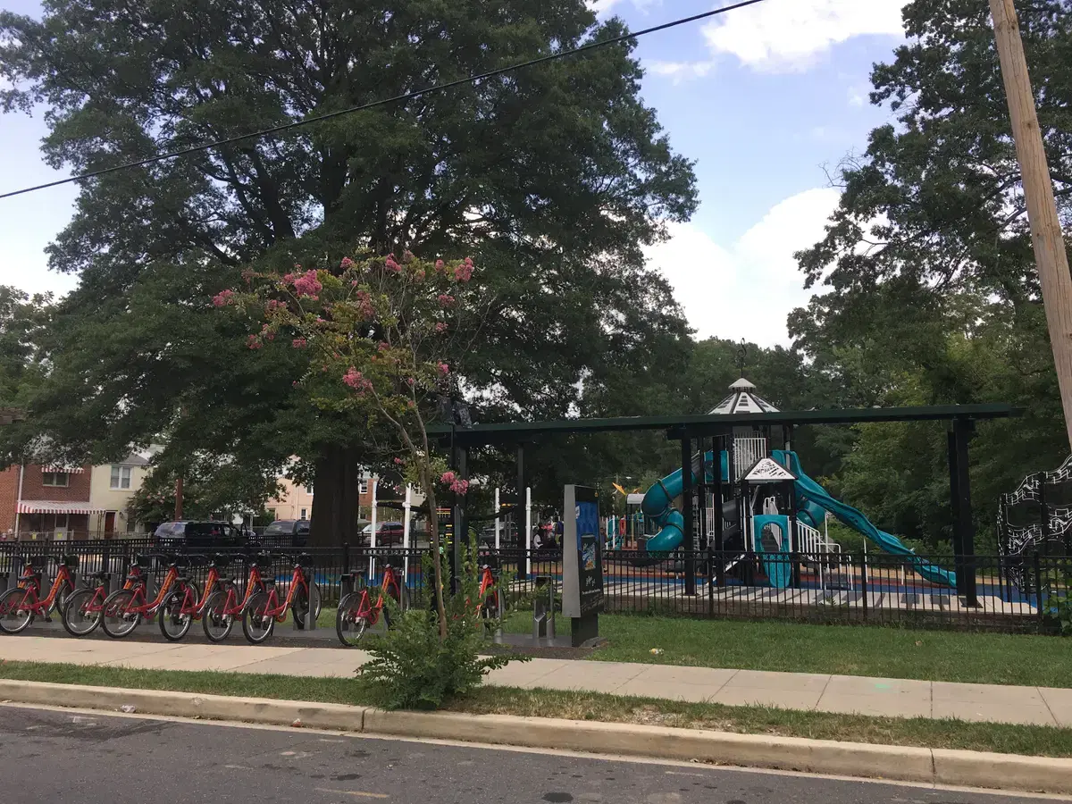 The playground and Capital Bikeshare rack at the Marvin Gaye Recreation Center in a leafy park setting, Washington, D.C.