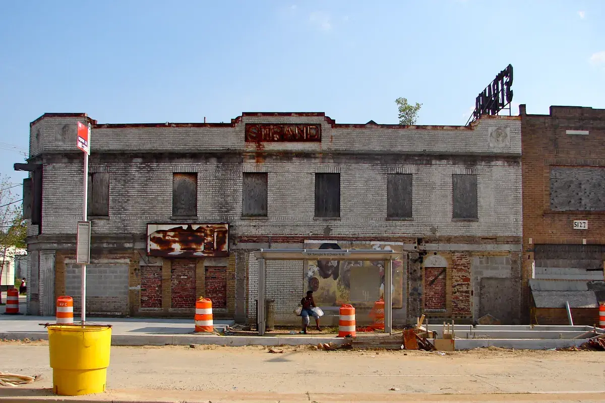 The Strand Theater's facade on Nannie Helen Burroughs Avenue with its STRAND sign, boarded up before restoration