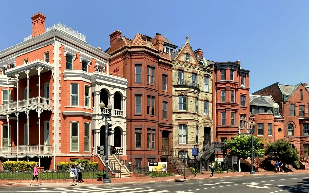 The Victorian mansion row at 4-9 Logan Circle NW — wraparound iron porches, bays, and turreted stone fronts, Washington, D.C.