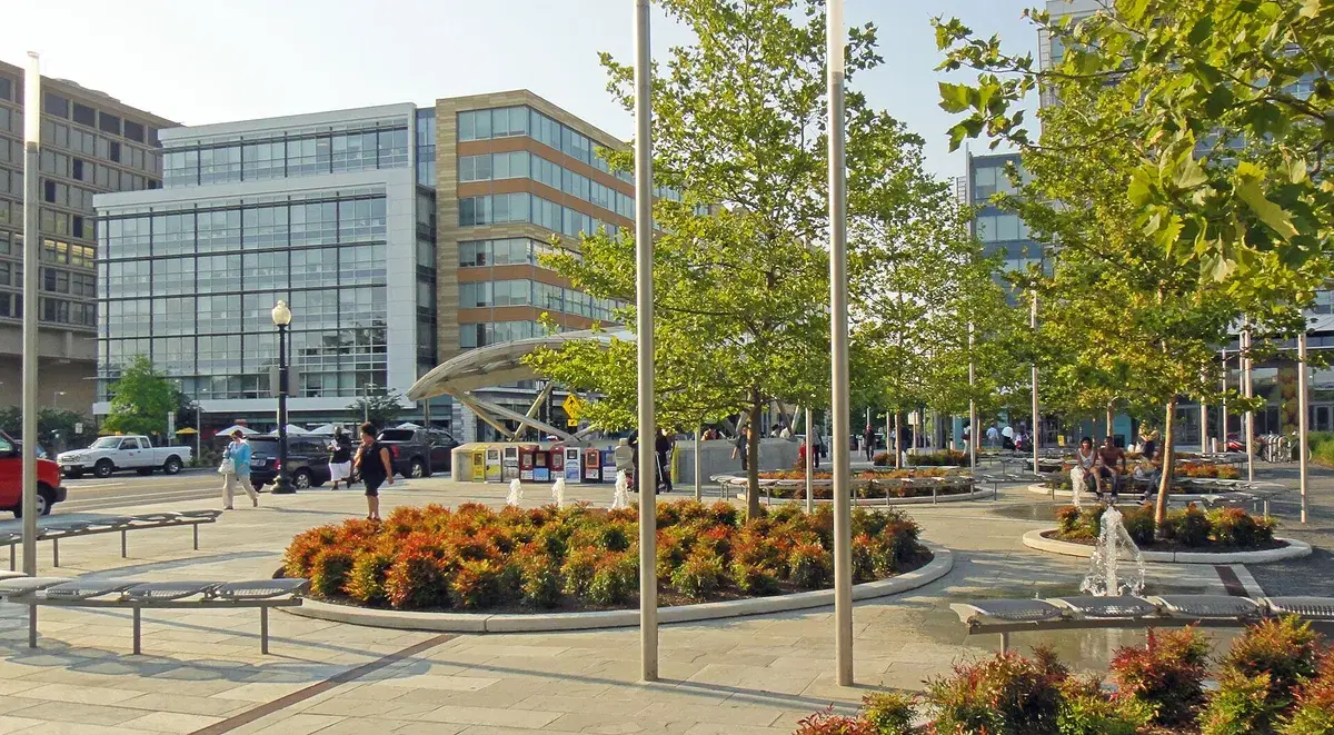 The plaza at 4th and M streets SW, with the Waterfront Metro entrance canopy behind the trees