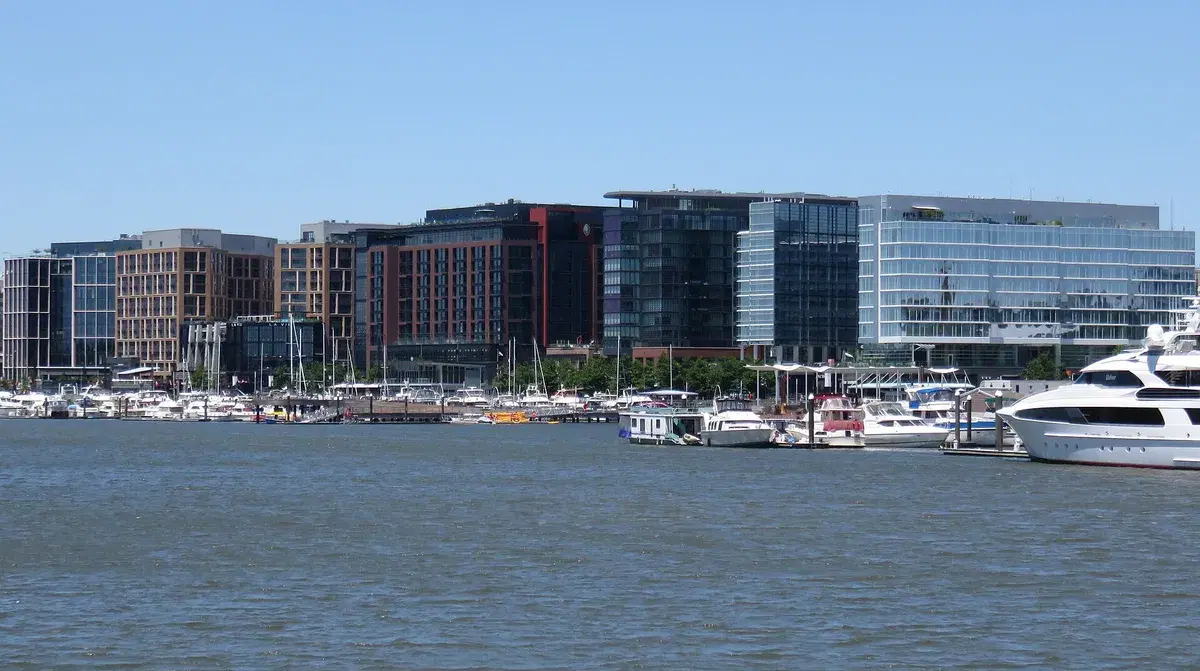 The Wharf's buildings and marina seen from the water on a clear day