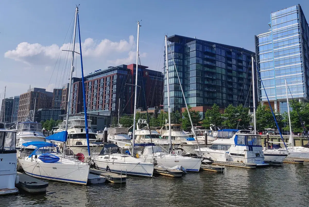 Sailboats in the Wharf's marina with the promenade and buildings behind