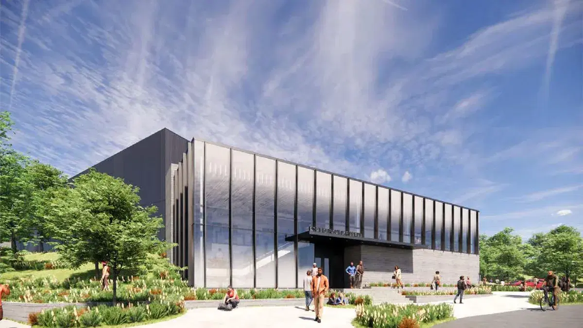 Architect's rendering of the rebuilt Fort Dupont Ice Arena, a tall dark metal-and-glass building with landscaped walkways