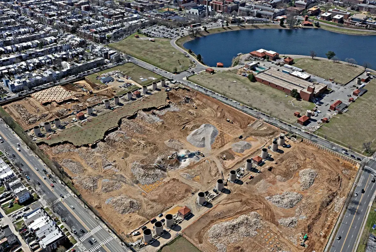 Aerial view of the cleared site with two rows of sand bins left standing, and McMillan Reservoir behind