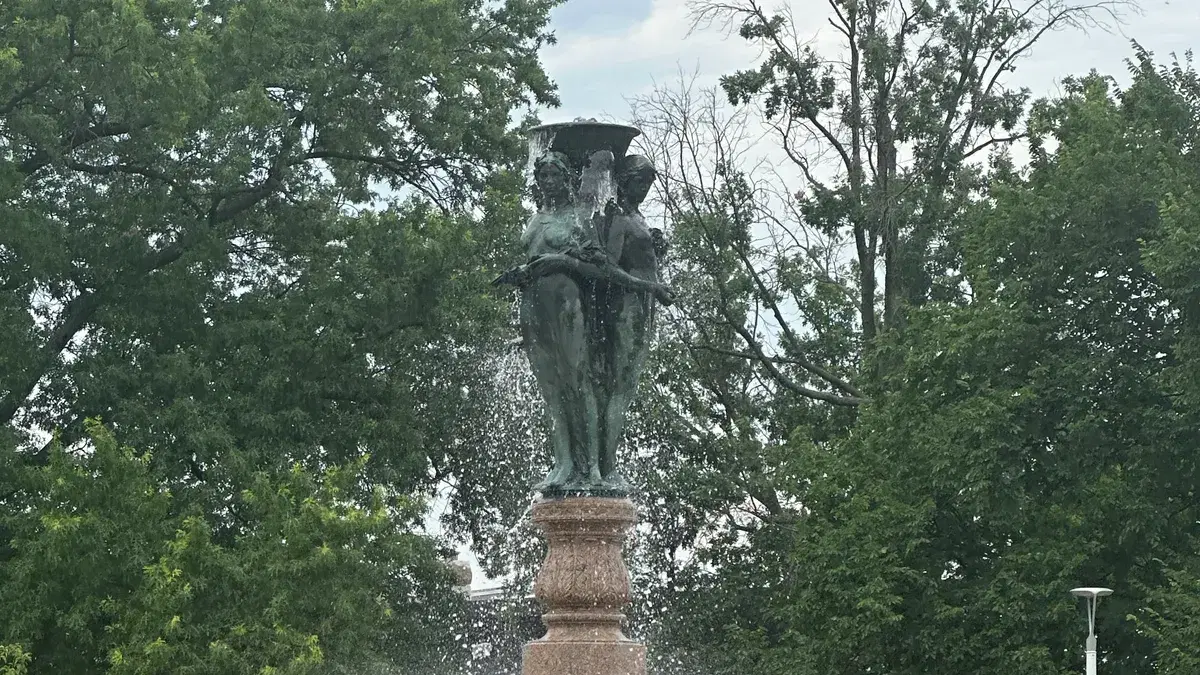 The McMillan Fountain's bronze Three Graces on a pink granite base, with water running, in Reservoir Park
