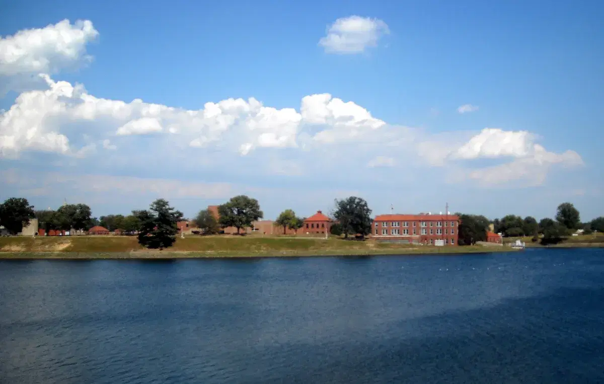 McMillan Reservoir's blue water with red-brick waterworks buildings on the far bank