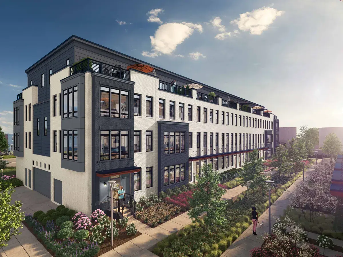 Rendering of a long row of four-story white and dark brick townhomes with roof terraces along a planted walk