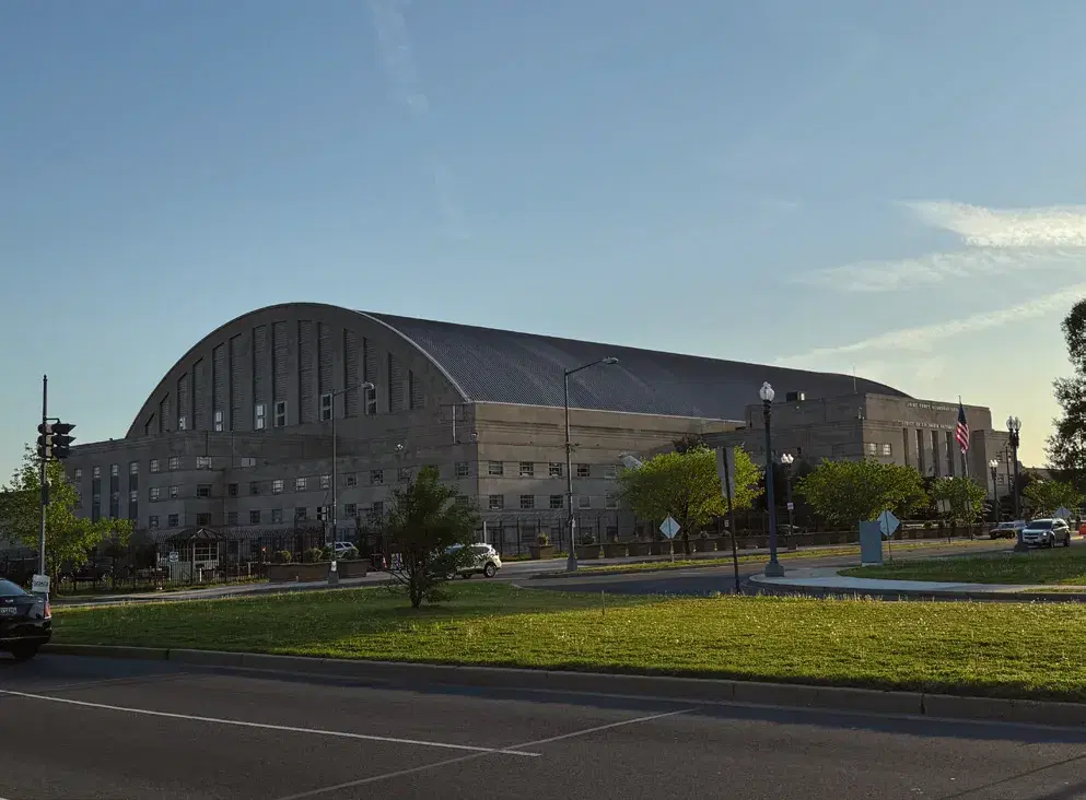 The DC Armory's long arched roof and brick front at sundown