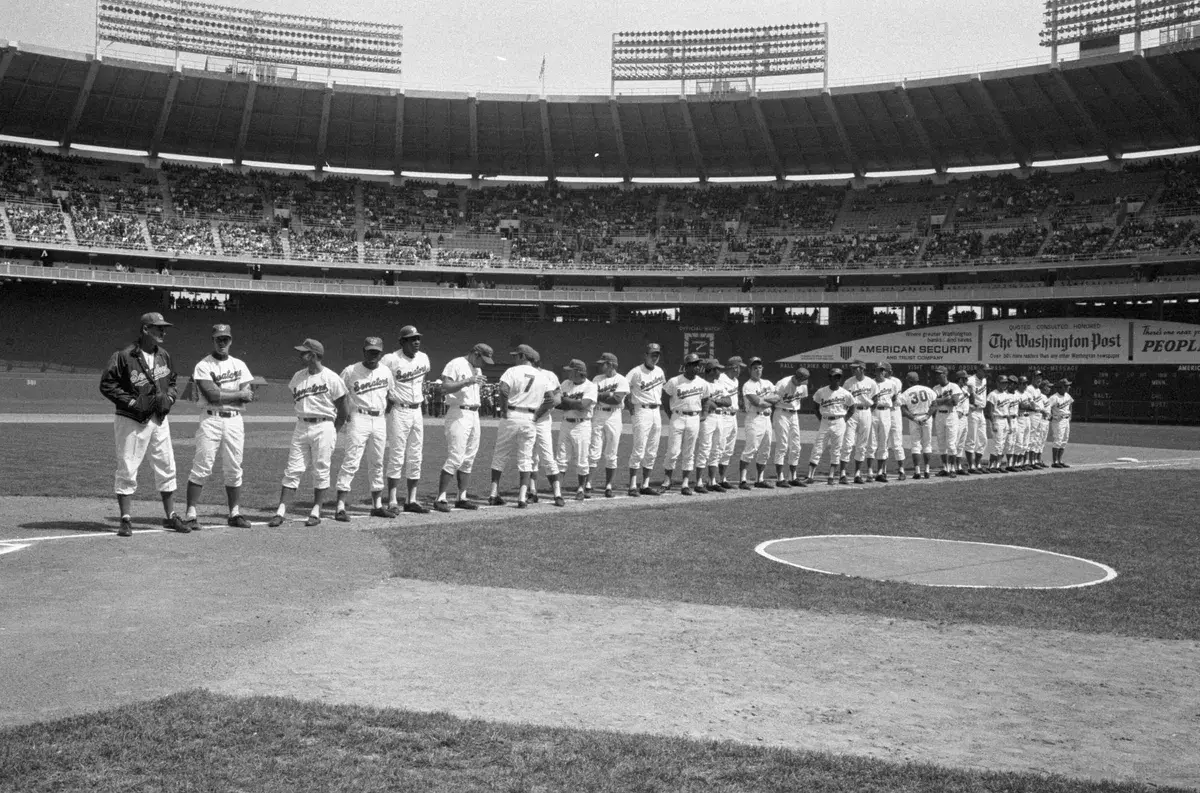 Washington Senators players lined up on the foul line before full stands on opening day