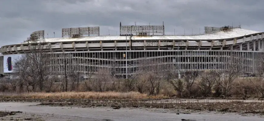 The empty RFK Stadium, its upper deck stripped, seen across open ground