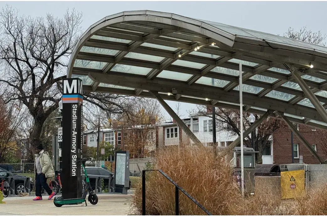 The glass canopy and Metro pylon at the Stadium-Armory station's south entrance