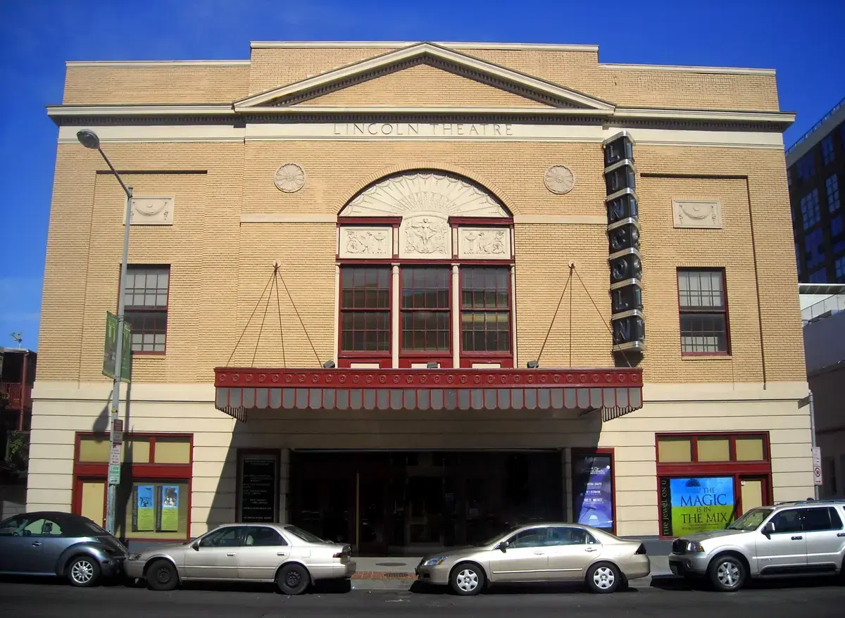 Full frontal facade of the Lincoln Theatre on U Street, blue sky, vertical LINCOLN marquee sign