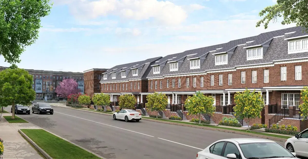 Rendering of Canopy Row's brick townhomes with porches and dormers along a tree-lined street