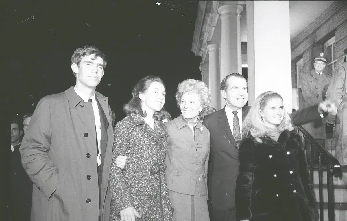 President-elect Richard Nixon and his family on the steps of Walter Reed at night