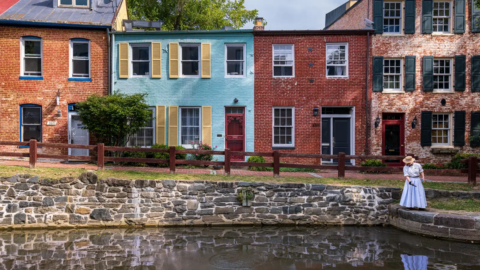 Brightly painted historic rowhouses reflected in the C&O Canal in Georgetown, Washington, D.C.