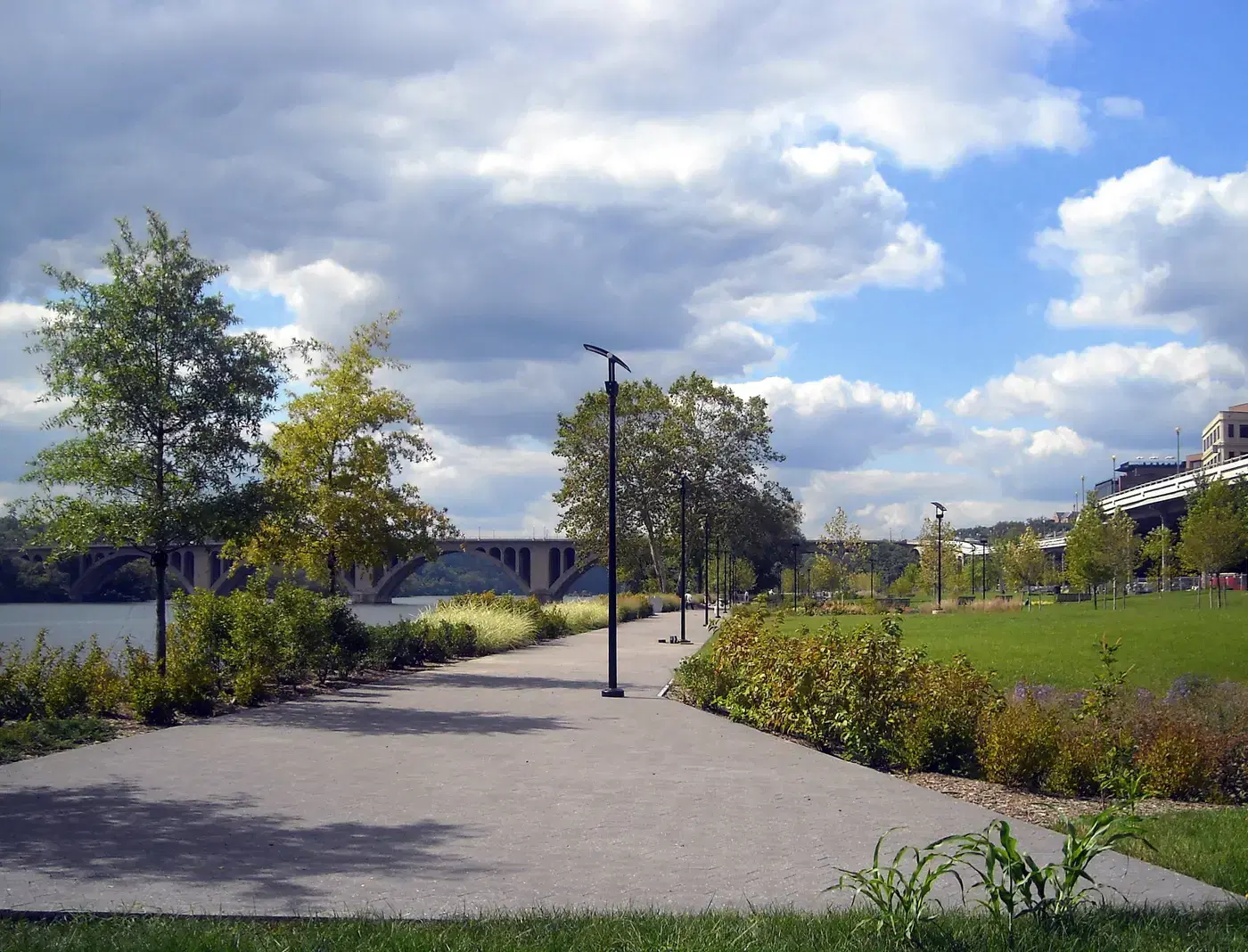 The riverside path at Georgetown Waterfront Park with Key Bridge beyond, Washington, D.C.