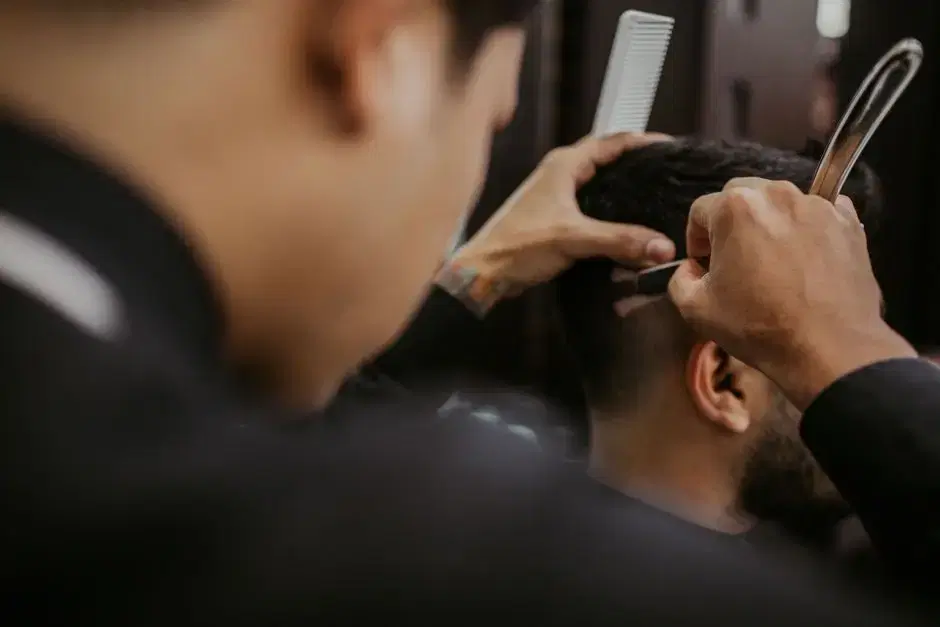 Thematic: barber at work close-up (card cites barbershops on the local main street); no brand or location cues