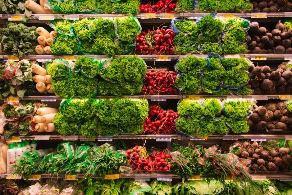 Colorful stocked produce wall: lettuce, radishes, beets, herbs with price tags