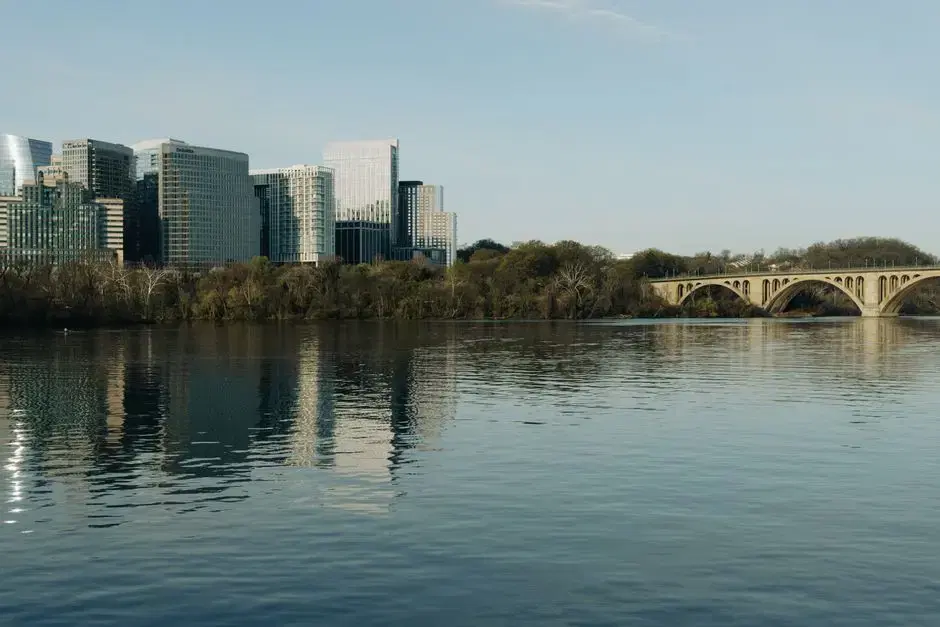 The Potomac with Key Bridge (Rosslyn skyline across the river) — the view from Georgetown's waterfront; honest DC imagery for the waterfront half of the card
