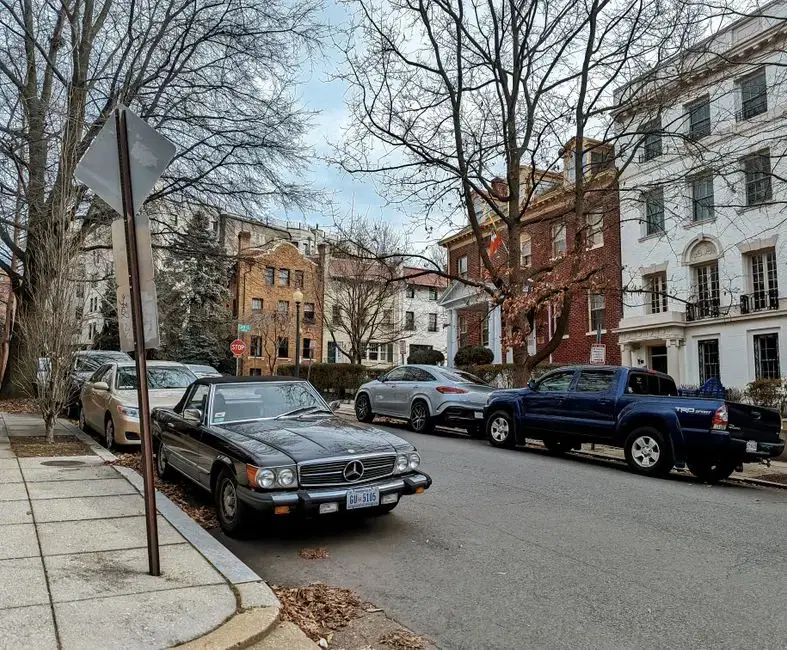 Quiet Washington DC residential side street with historic houses and a classic Mercedes on DC plates — honest DC side-street imagery (not the Dumbarton Oaks gardens themselves)