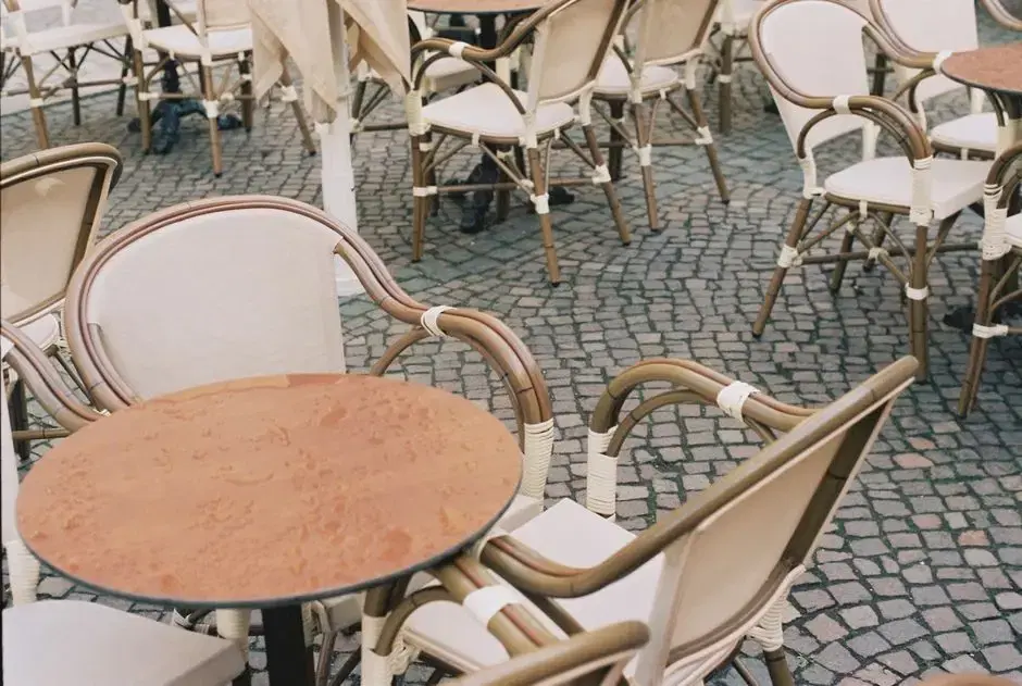 Thematic: rattan French-bistro sidewalk tables (the Le Diplomate look) shot close with no location cues