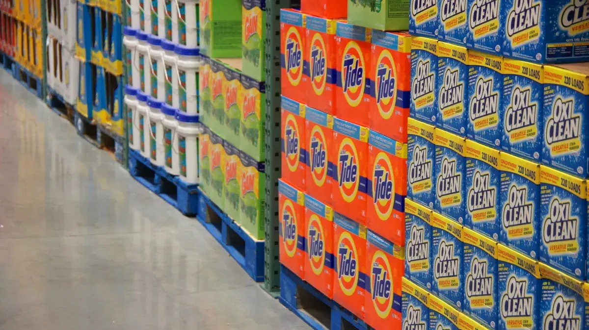 Pallets of laundry detergent stacked along an aisle inside the Costco