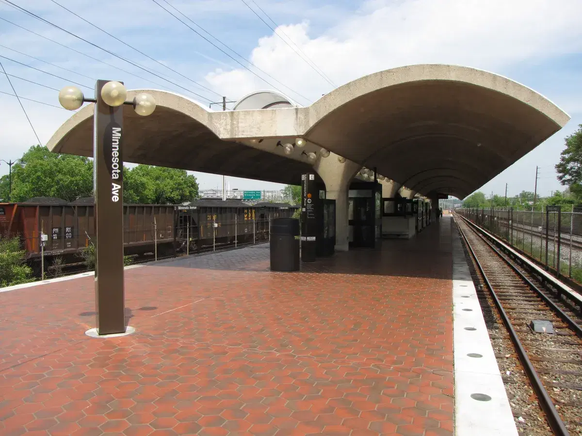 The Minnesota Ave station platform under its concrete canopy, with the station name on a pylon