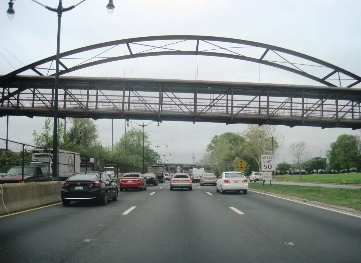 The Parkside Pedestrian Bridge, a steel arch and truss walkway, spanning DC-295 near Minnesota Ave Metro