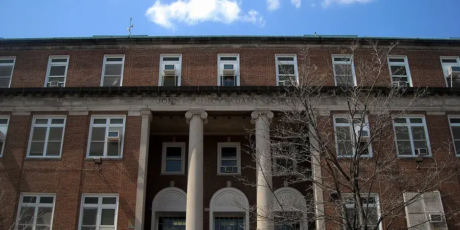 The columned brick entrance of the John Quincy Adams building of Oyster-Adams Bilingual School, Adams Morgan, Washington, D.C.