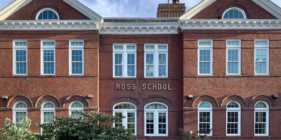The Victorian brick facade of John W. Ross Elementary School, its name carved in stone above the entrance, Dupont Circle, Washington, D.C.