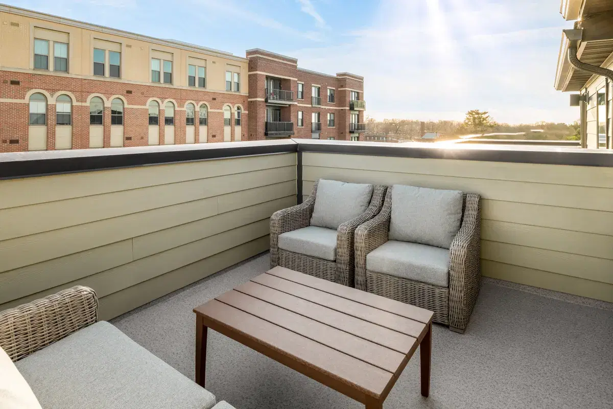 A furnished rooftop terrace on a Skyland townhome, with the Crest apartments behind