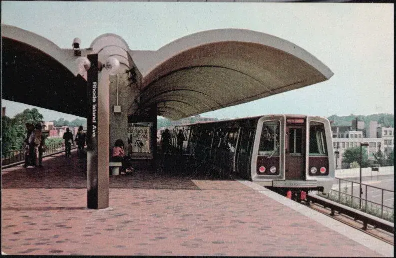A 1976 postcard of a Metro train at the curved-canopy Rhode Island Ave station platform