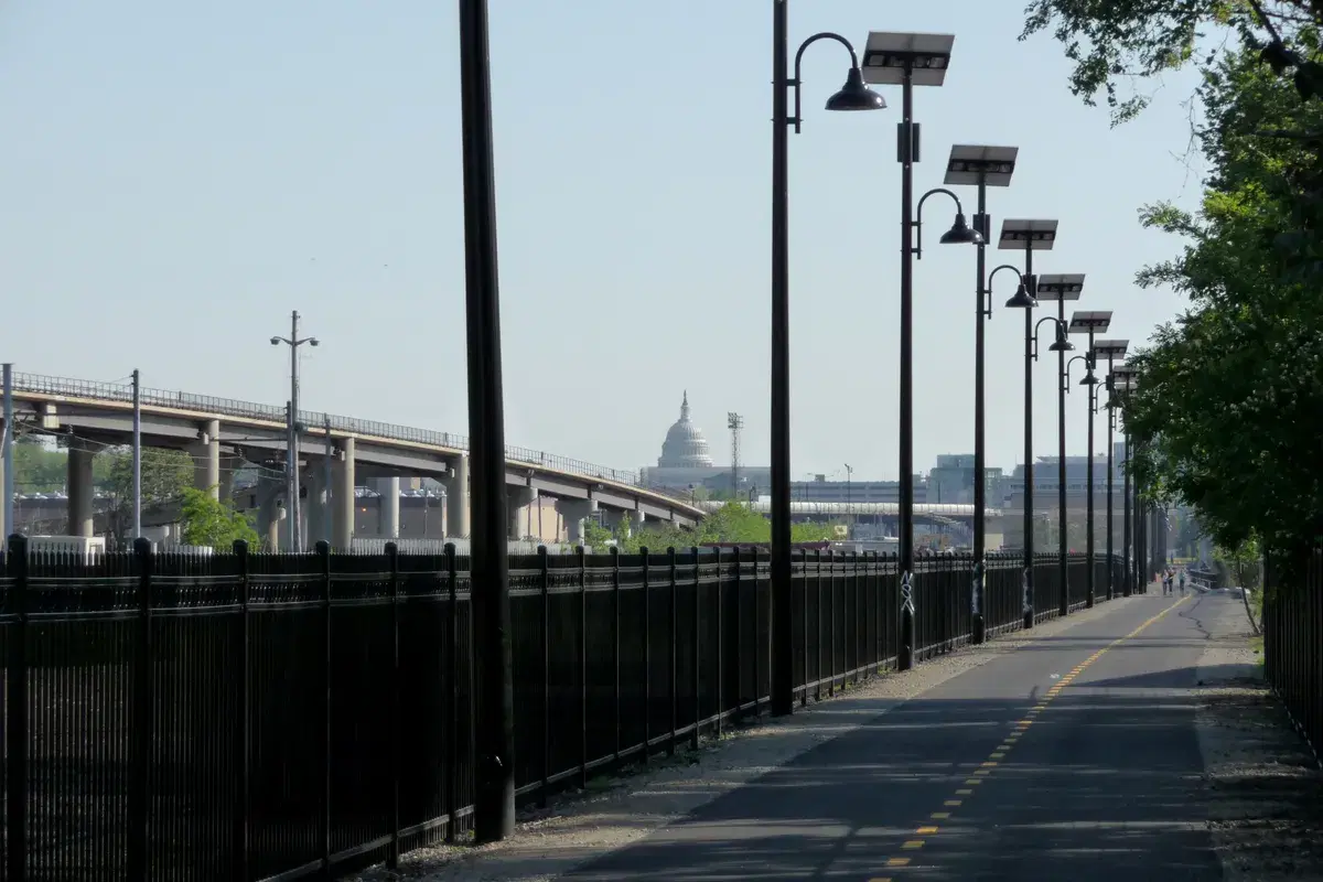 The Metropolitan Branch Trail lined with solar-powered lamps, the Capitol dome in the distance