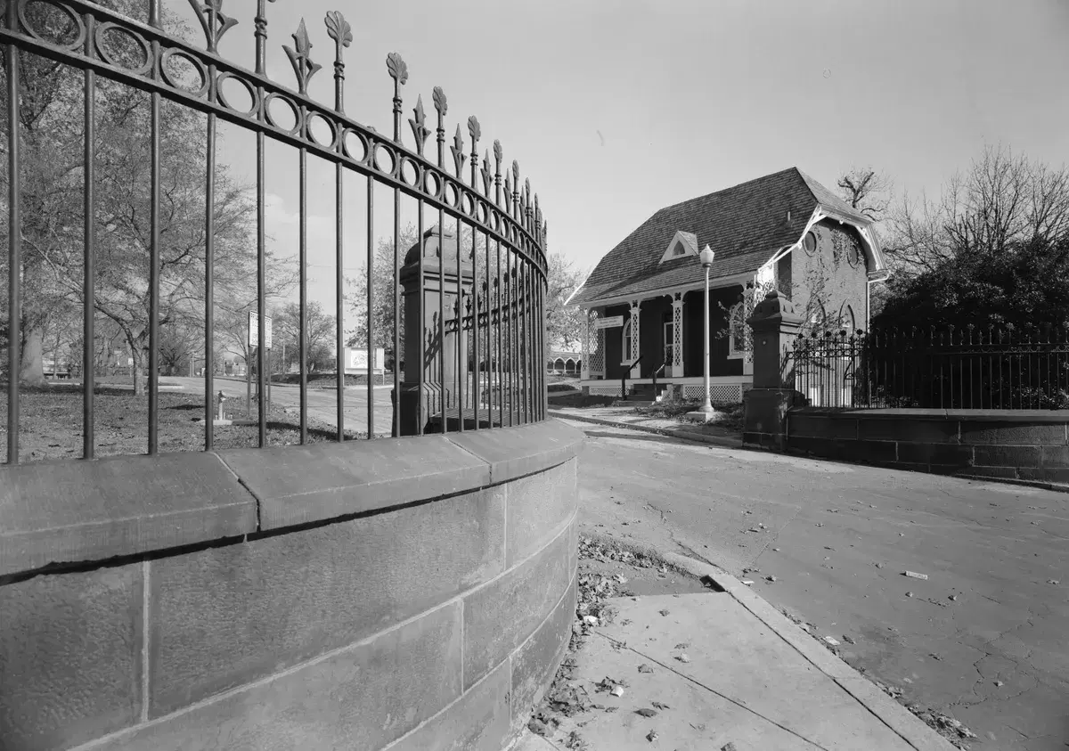 The Victorian gate house and curved iron fence at Gallaudet's Florida Avenue entrance, in a black-and-white survey photograph.