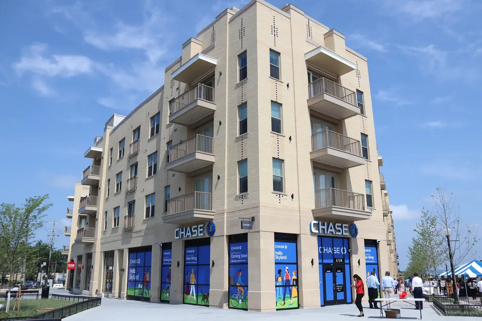 The five-story corner of the Crest apartments at Skyland Town Center under a blue sky, June 2021