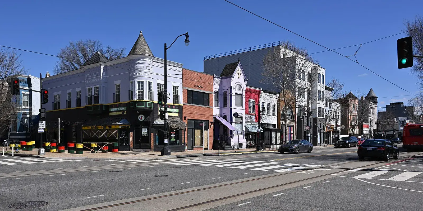 Turreted corner shops and rowhouses on the north side of the 1100 block of H Street NE, Washington, D.C.