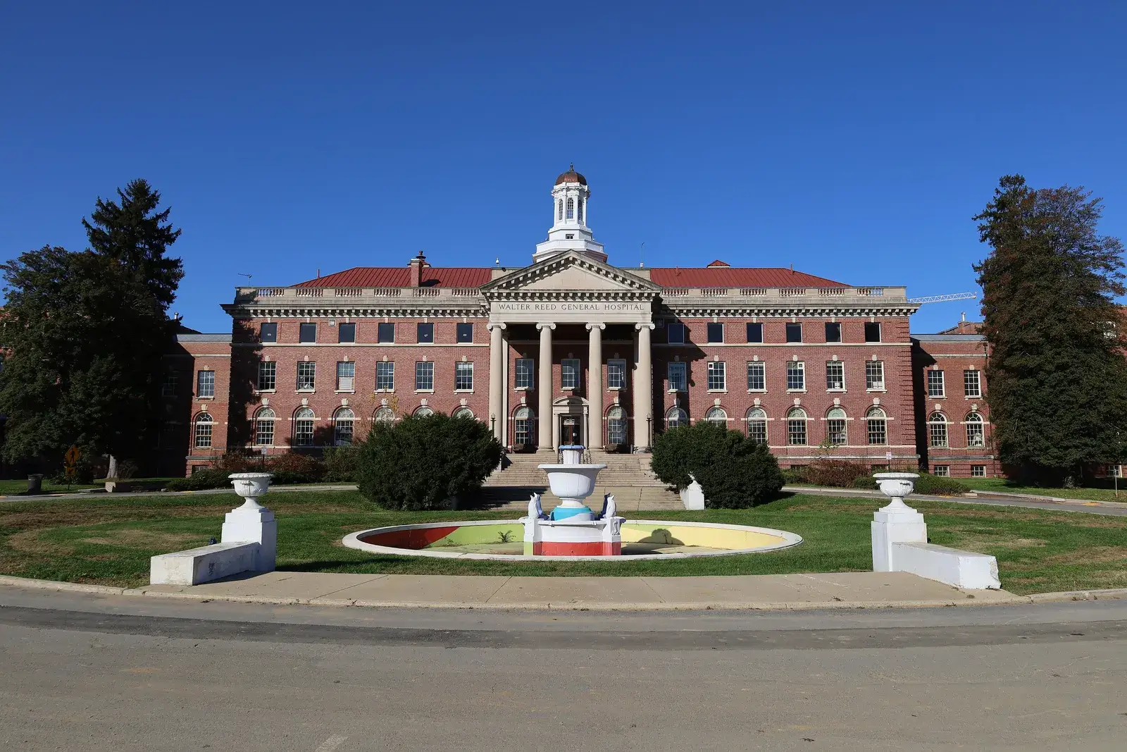 Walter Reed's historic Building 1, with its columned portico and cupola, behind a round fountain, Washington, D.C.